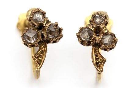 A pair of small diamond ear screws. Shaped like a 