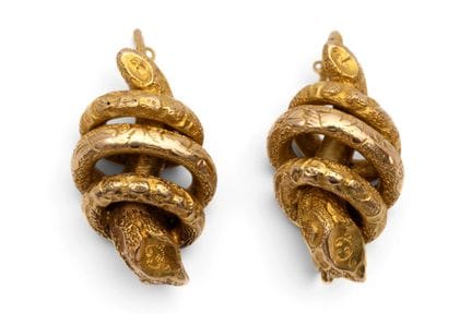 A pair of mid-19th-century snake earrings. Each is