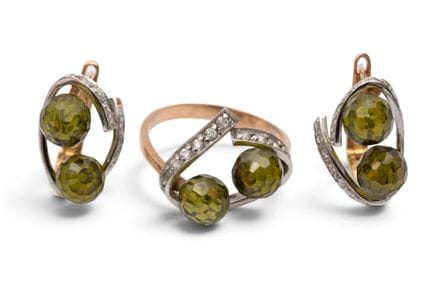 A pair of gem-set earrings with a matching ring. E