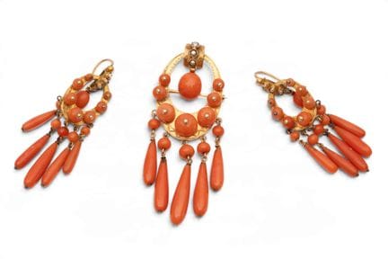 A set of coral earrings and a matching brooch. Eac