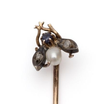 An early 20th-century lapel pin depicting a small 