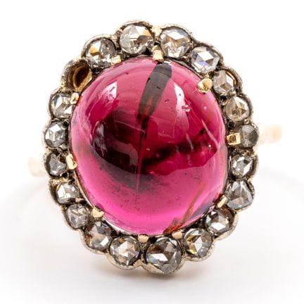 A garnet and diamond cluster ring. Set with a clar