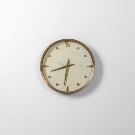 A WALL CLOCK from the 1950s.
Brass and glass.
In w