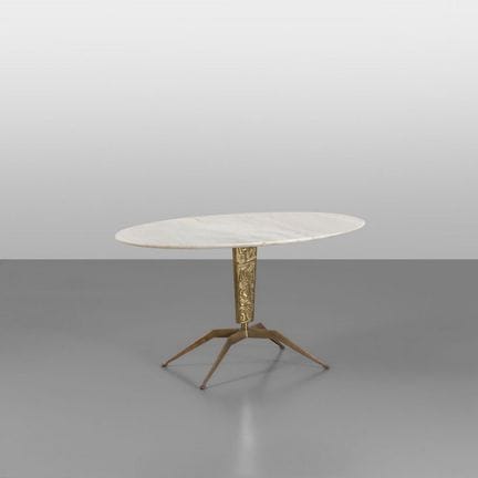 A COFFEE TABLE from the 1950s. 
Brass legs with a 