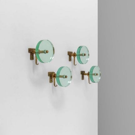 FOUR WALL-MOUNTED COAT HOOKS  from the 1950s. 
Bra
