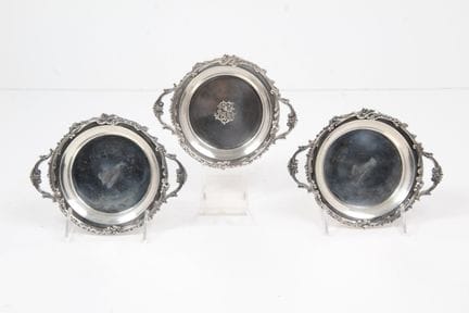 THREE SMALL SILVER BOTTLE COASTERS WITH HANDLES, 9
