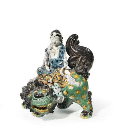 JAPAN
A polychrome glazed porcelain group depictin