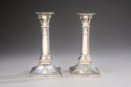 Pair of 800-thousandths silver table candlesticks,