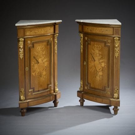 Pair of corner cabinets with arched fronts, featur