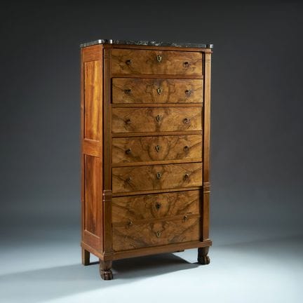A walnut chest of drawers with molded burl walnut 