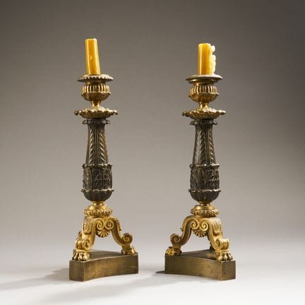 Pair of bronze candlesticks with a golden and brow