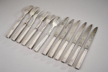 A set of six knives and six meat forks; the handle