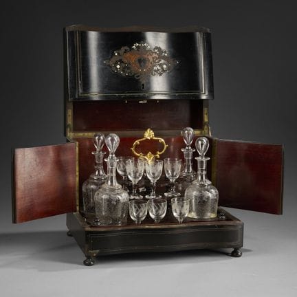 Blackened wooden liquor cabinet decorated with mar