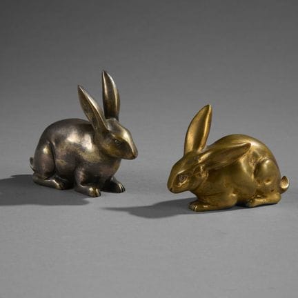 CLAUDE (20th century).
Two small bronze rabbits, o