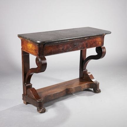 A substantial console table made of mahogany and m