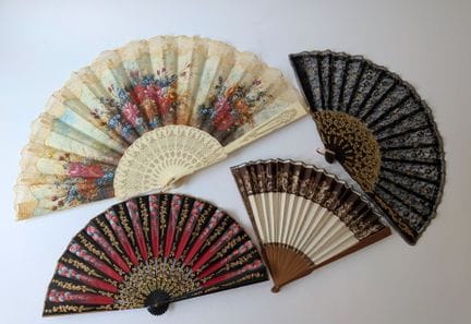 Set of four fans, including: 
- A folding fan with