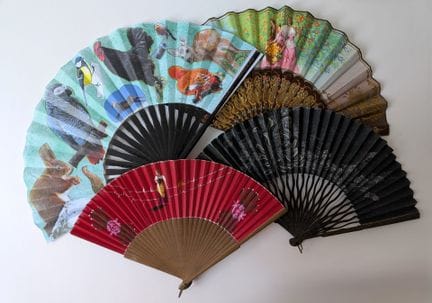 A set of four fans, including: 
- A folding fan wi
