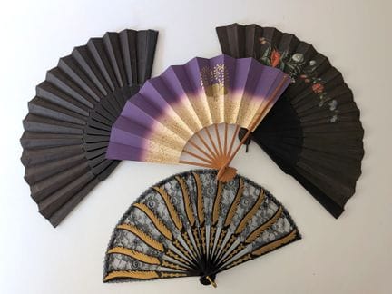 Set of four fans, including: 
- A folding fan with