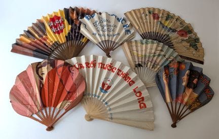 A set of seven printed wooden and paper advertisin