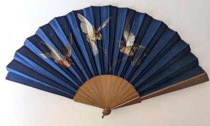 Folded fan, with wooden ribs and a midnight blue s