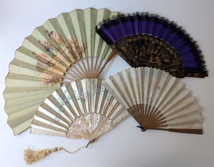 A set of four fans, including: 
- A folding fan wi