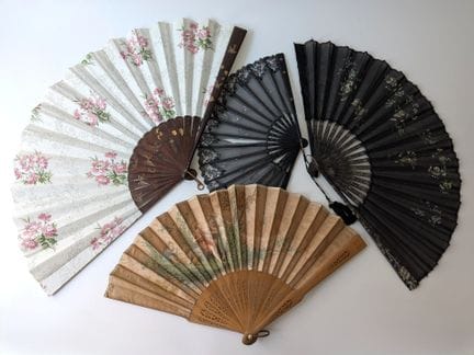 A set of four fans consisting of: 
- A folded fan,