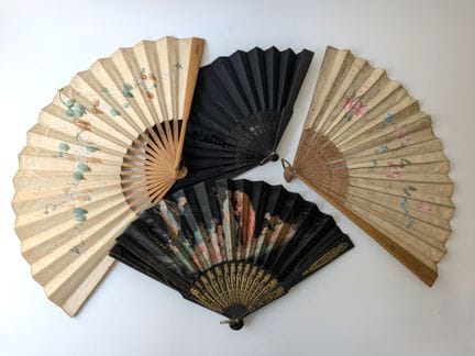 A set of four fans comprising: 
- A folding fan wi