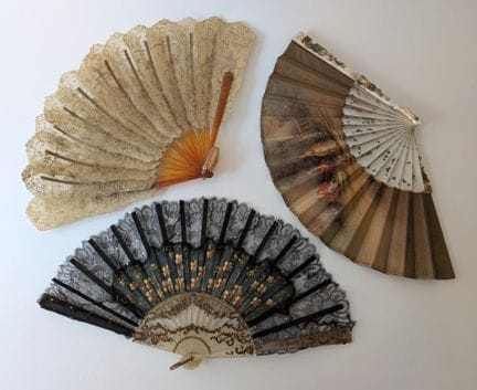 A set of three fans comprising: 
- A folding fan w