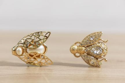CHRISTIAN DIOR - Lot de deux broches figurant une 