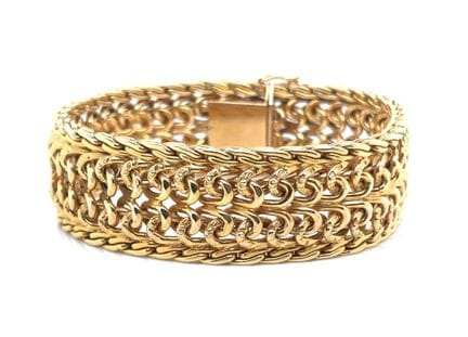 BRACELET: braided gold (750‰) band. Snap clasp wit