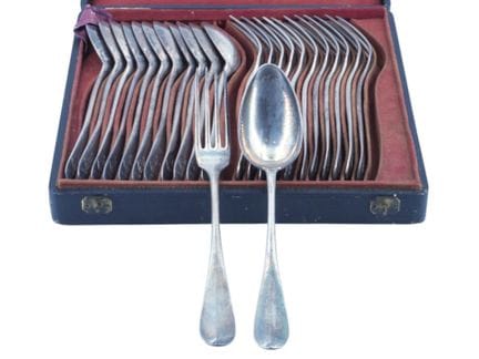 A silver (950‰) tableware set with a plain design,