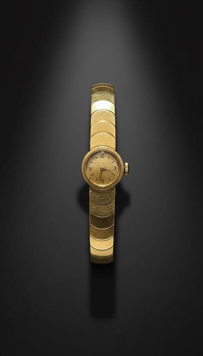 Kleine Uhr mit rundem Zifferblatt aus 750er Gold 
