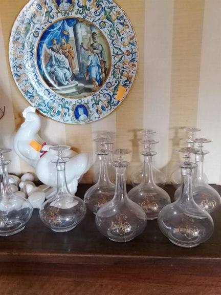 Set of ten glass carafes with a gilded appliqué nu