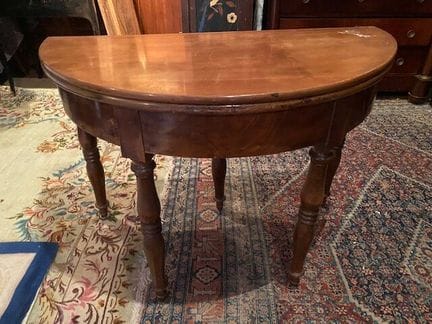 A half-moon table made of mahogany and mahogany ve