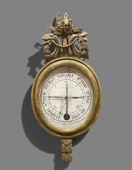 Baromètre ovale en bois sculpté et doré à motifs d