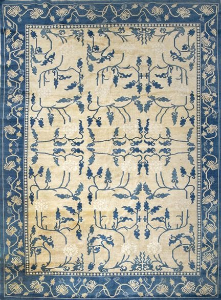 Chinese wool rug with a light field and blue borde