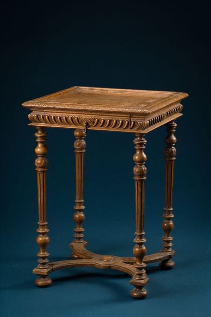 Square side table made of natural wood, resting on