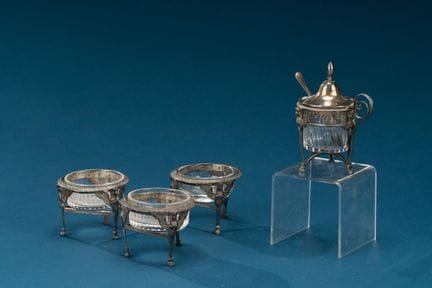 Set of three silver salt shakers and one mustard s