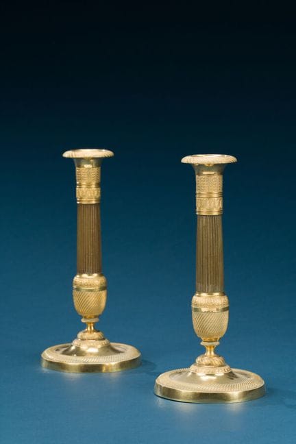 Pair of patinated and gilded metal candlesticks, d