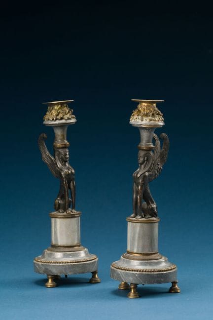 Pair of patinated and gilded bronze candlesticks, 