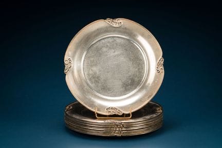 A set of eleven silver-plated display plates with 