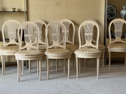 SET OF EIGHT rattan-seated chairs with lyre-shaped