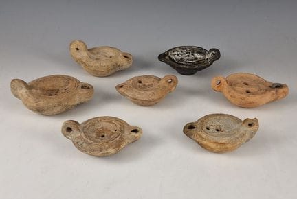 SEVEN TERRACOTTA OIL LAMPS, six of which date from