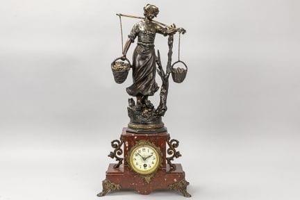 clock with a metal sculpture after Moreau and a ca