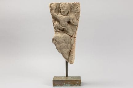 antique Khmer-style sculpture depicting a dancer o