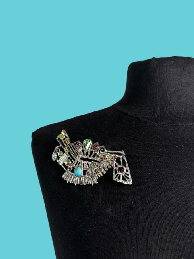 CHRISTIAN LACROIX Made in France  Modernist brooch in silver plated metal adorned with multicolored rhinestones—signed
10 x 5.5 cm