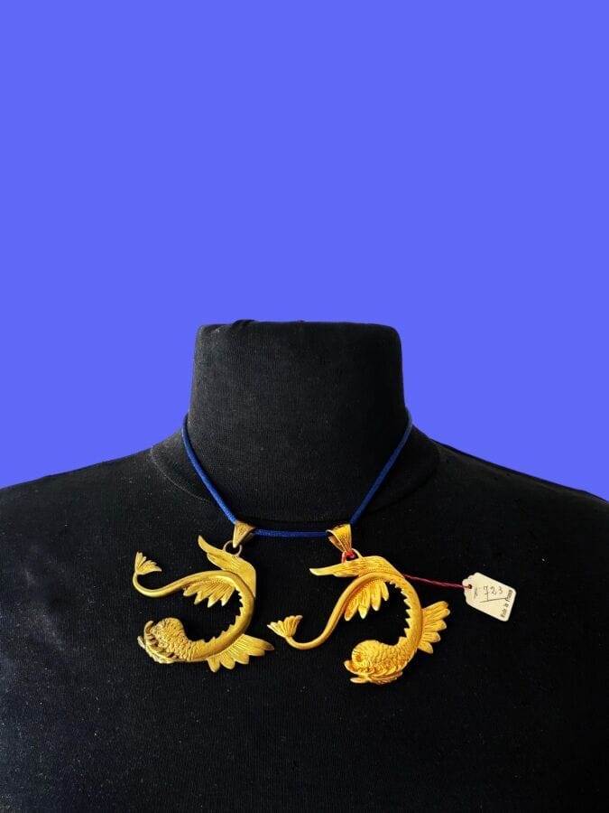 PAUL WIEGANT Two  fish pendants made of gilded and patinated metal—unsigned, with stock label
Height: 6 cm
