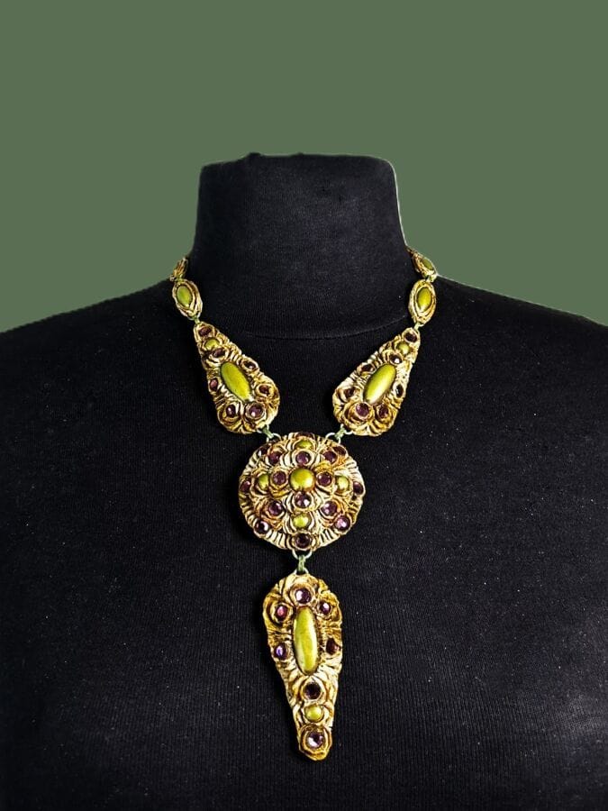 HENRY Patterned necklace with Talosel pendant featuring green patinated metal cabochons and mauve rhinestones—signed
Height: 32 cm
