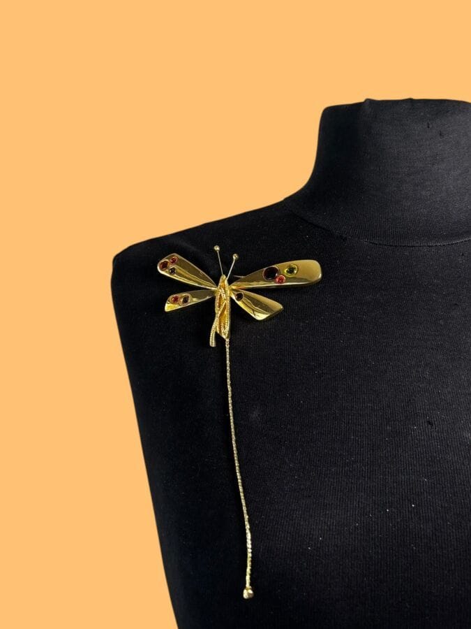 CHRISTIAN LACROIX Broche papillon en métal doré et cabochons de verre de couleur- signée  
Ht : 17 cm 
Largeur : 9,5 cm
