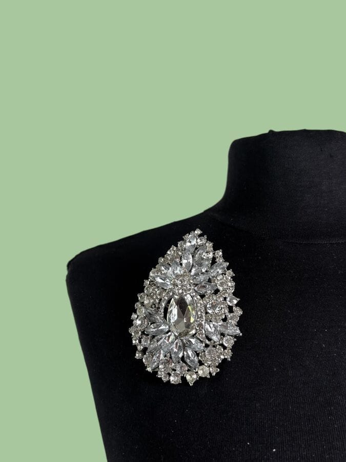 Attributed to  YVES SAINT LAURENT  Silver-patinated metal brooch set with rhinestones 
9 x 6.5 cm